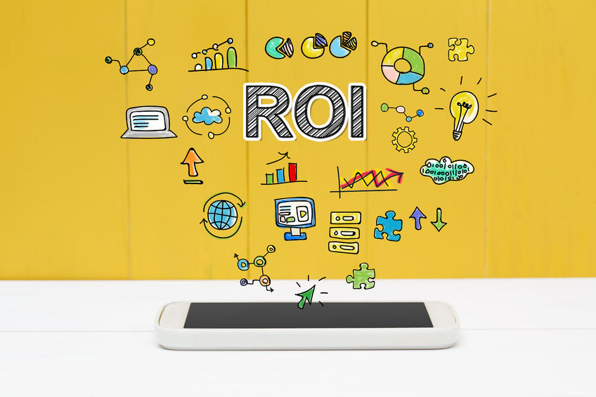 roi concept with smartphone on yellow wooden background